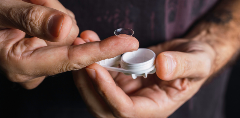 person taking out the contacts from container