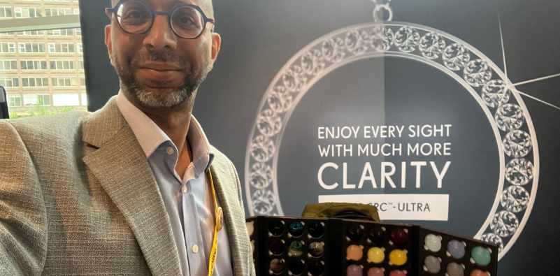 Mohamed Kasmani, owner of Feltham Eyecare Centre stood in front of Seiko lens examples.